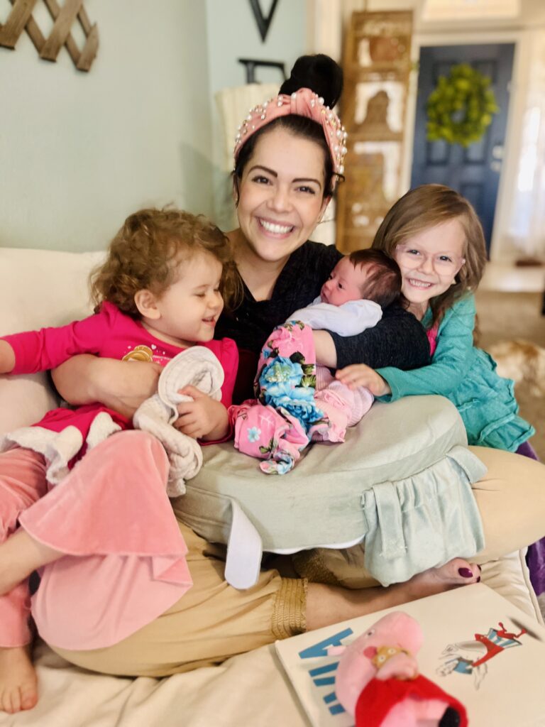 A young mother and three little girls. Filled with hope and love