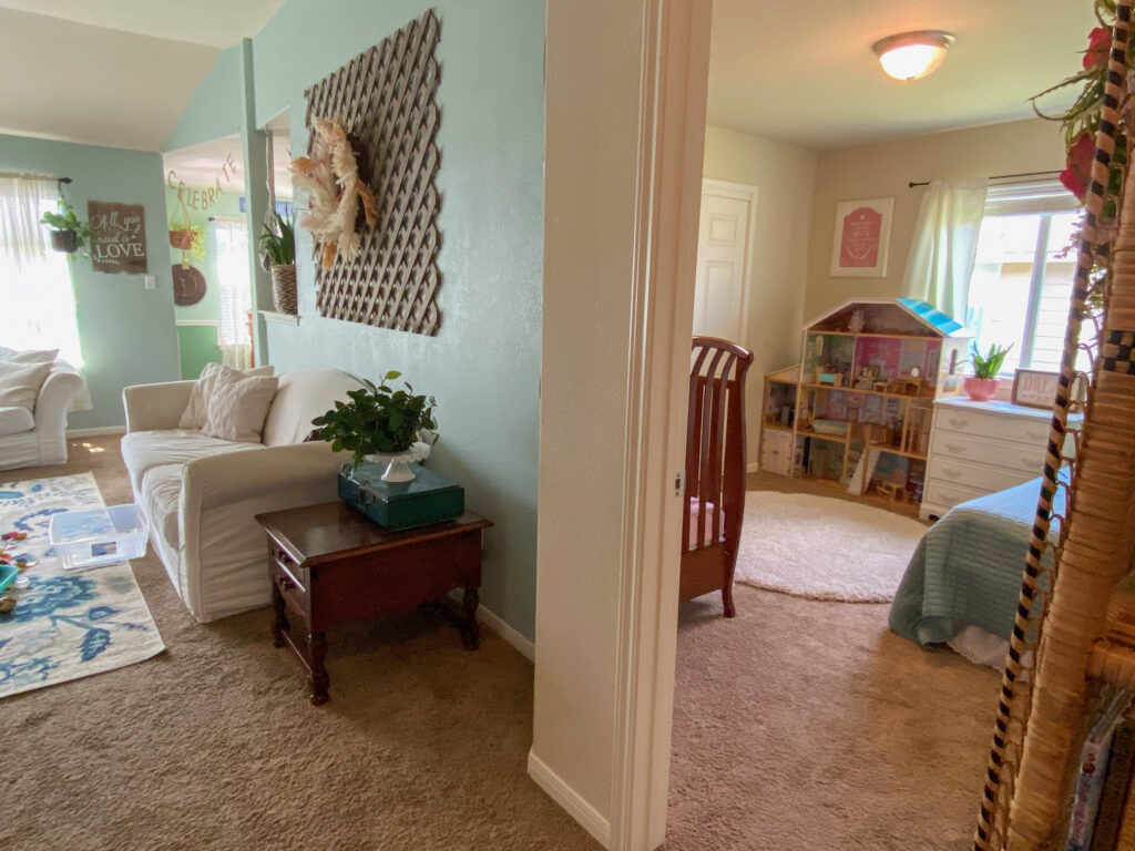 a cozy living room open floor concept, children's bedroom and playhouse within sight